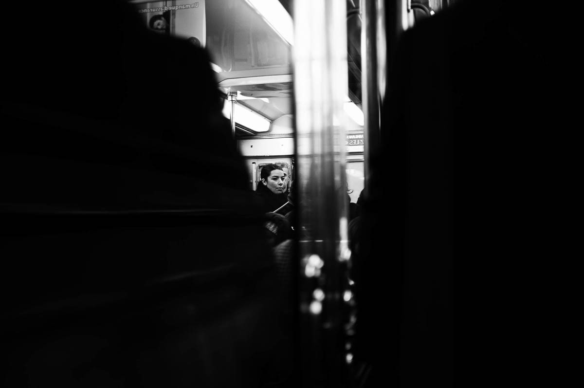 A woman standing in a Paris metro train, from the series Going Underground by Emmanuel Pineau